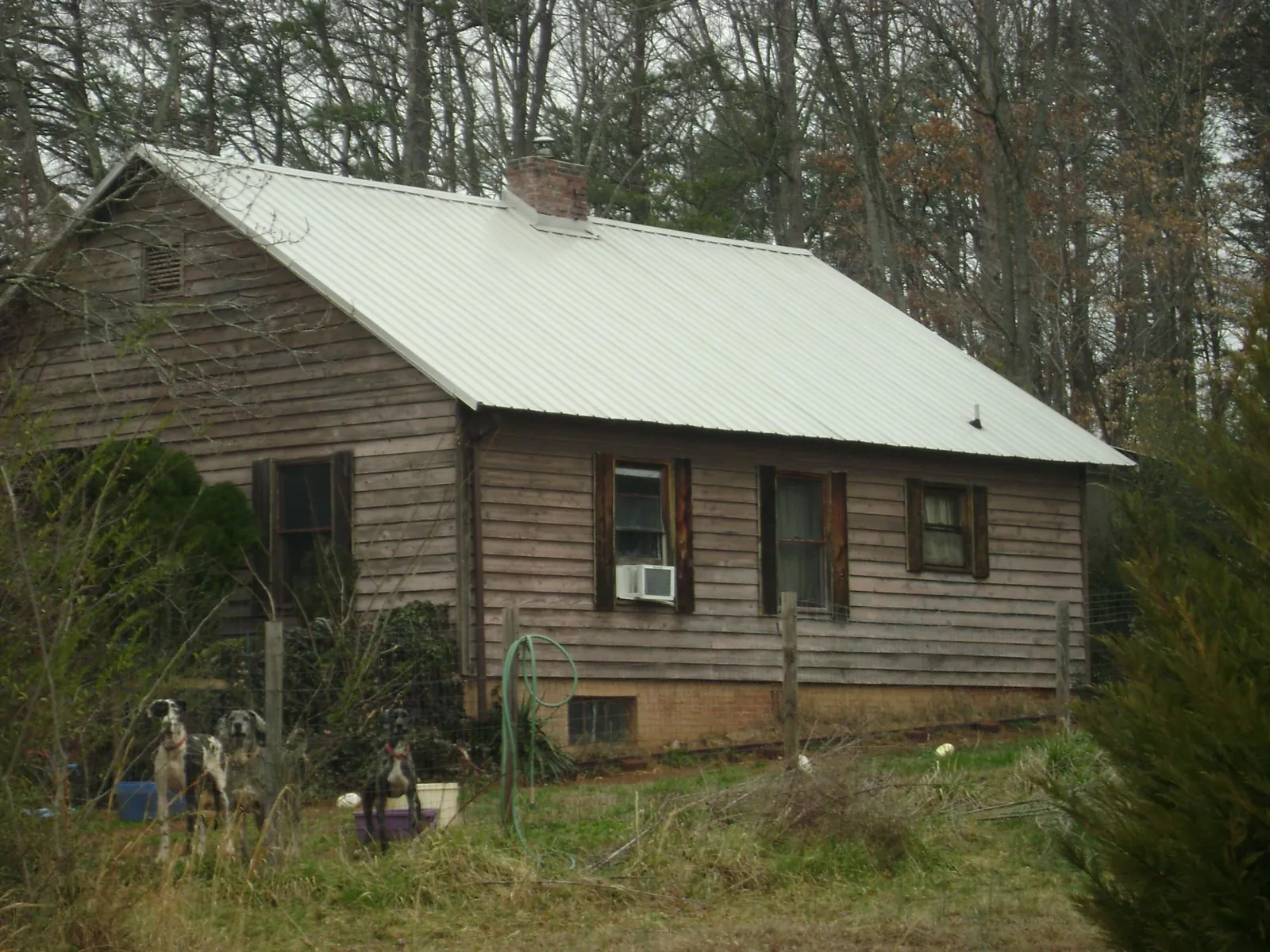 White metal roof on an old wood sided farmhouse, from a Metal Roof Installation job in George